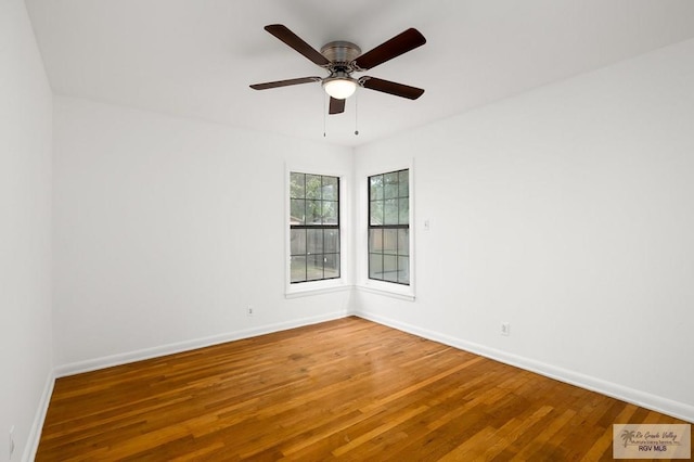 spare room with hardwood / wood-style floors and ceiling fan