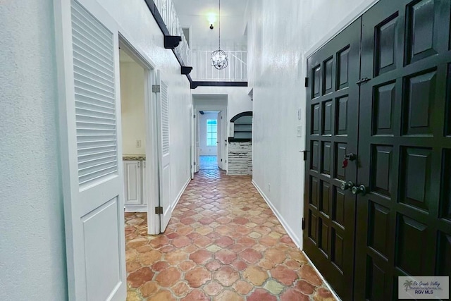 hallway with a chandelier