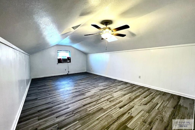 bonus room with a textured ceiling, lofted ceiling, ceiling fan, and dark hardwood / wood-style floors