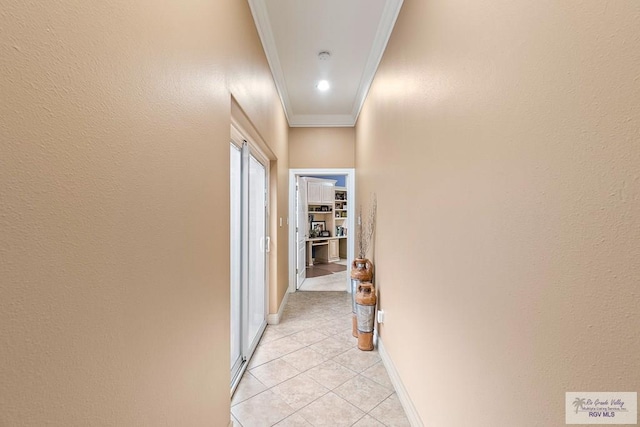 hallway featuring light tile patterned flooring and ornamental molding