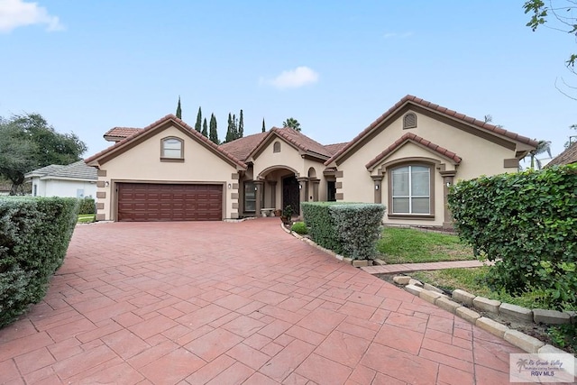 mediterranean / spanish-style house featuring a garage