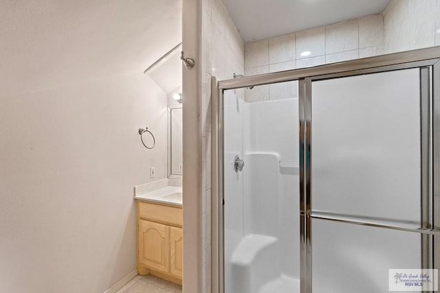 bathroom featuring vanity and a shower with door