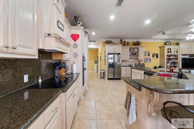 kitchen with sink, ceiling fan, light tile patterned floors, appliances with stainless steel finishes, and tasteful backsplash