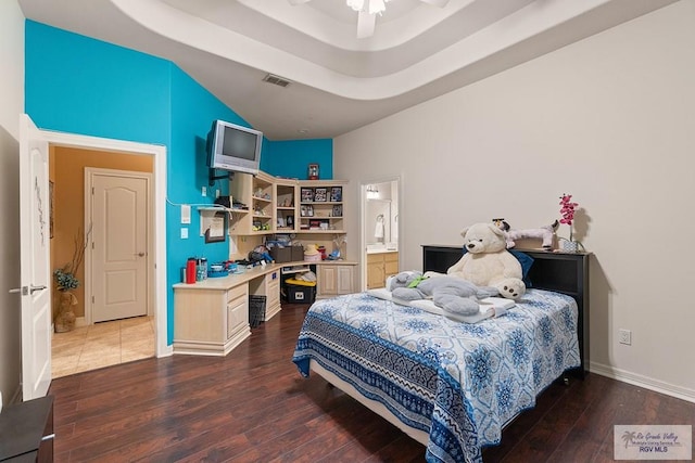 bedroom featuring ceiling fan, dark hardwood / wood-style flooring, and ensuite bathroom