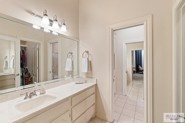 bathroom featuring tile patterned flooring and vanity