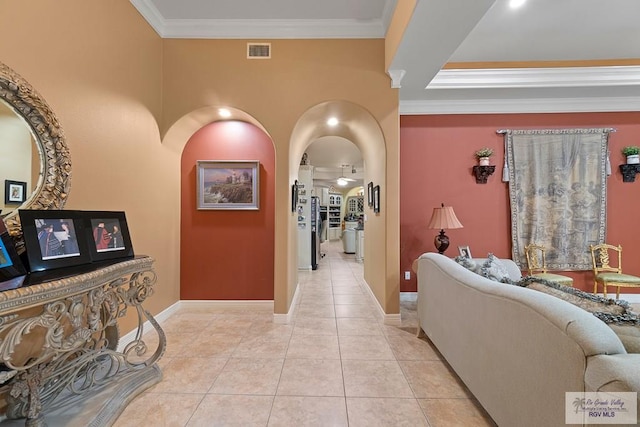 hallway featuring light tile patterned floors and ornamental molding