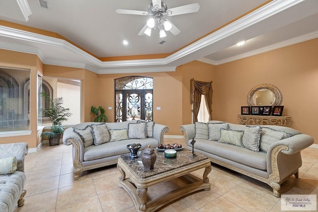 living room featuring light tile patterned floors, a raised ceiling, ceiling fan, and ornamental molding