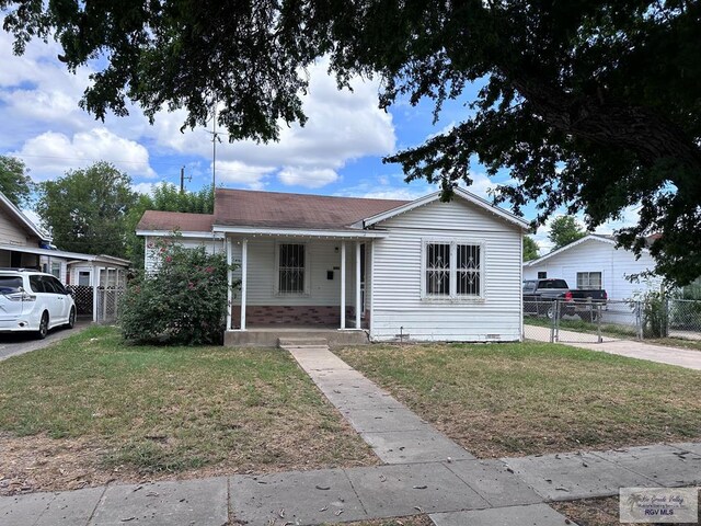 bungalow featuring a front yard and covered porch