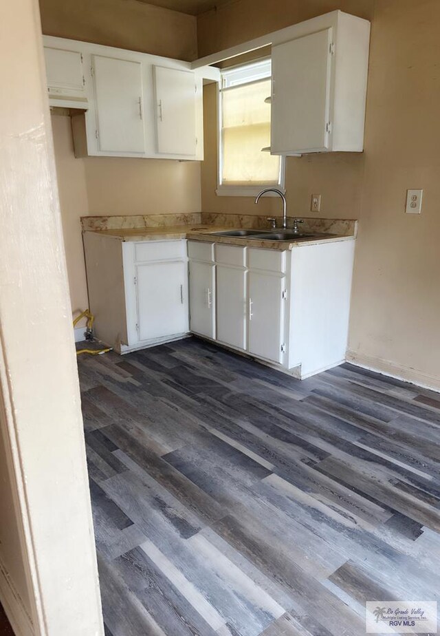 kitchen featuring white cabinets and dark hardwood / wood-style flooring