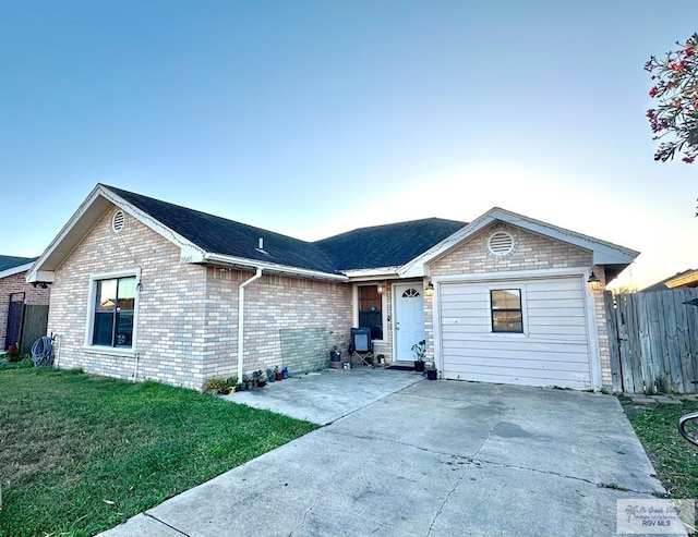 ranch-style house featuring a front lawn, fence, brick siding, and a patio