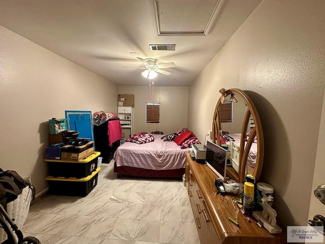 bedroom featuring visible vents, marble finish floor, attic access, and ceiling fan