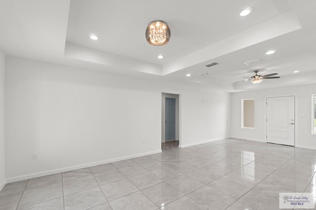 spare room featuring ceiling fan and a tray ceiling