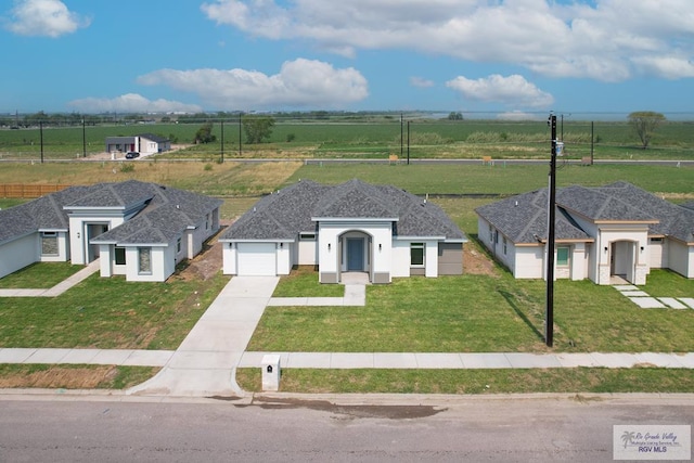 view of front of property with a garage and a front yard