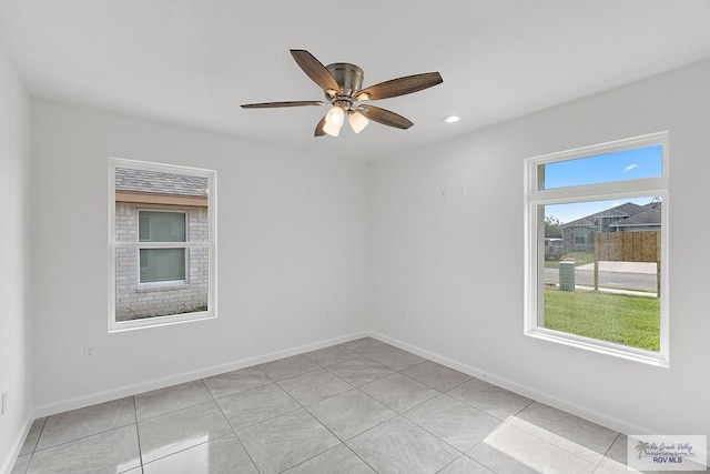 empty room with ceiling fan and light tile patterned flooring