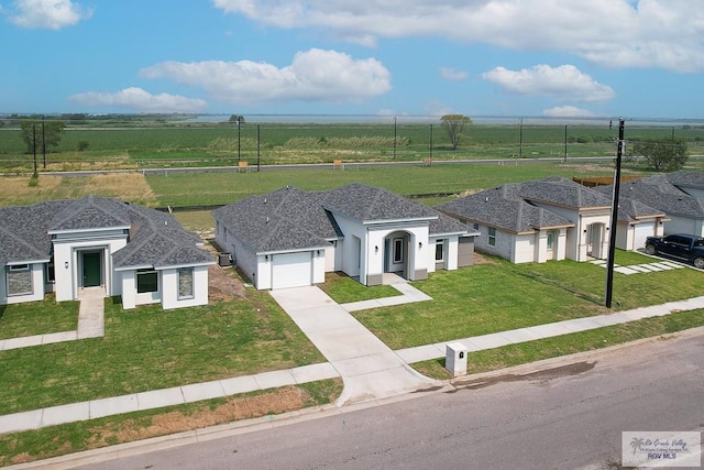 view of front of property with a garage and a front lawn