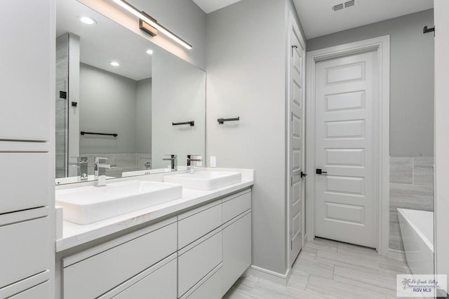 bathroom featuring vanity and a bathtub