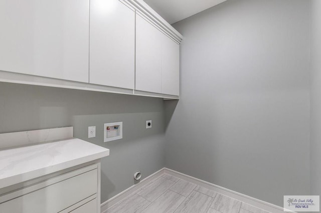 washroom featuring cabinets, washer hookup, and electric dryer hookup