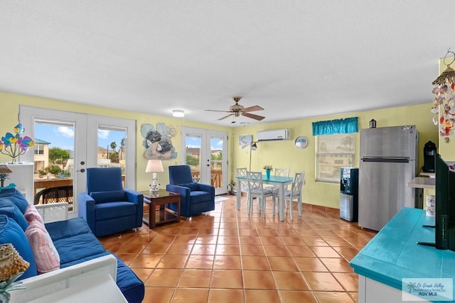 tiled living room with a wall mounted air conditioner, french doors, and plenty of natural light