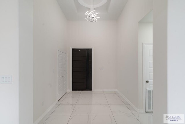 hallway with a notable chandelier