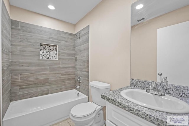 full bathroom featuring tiled shower / bath, vanity, toilet, and tile patterned flooring