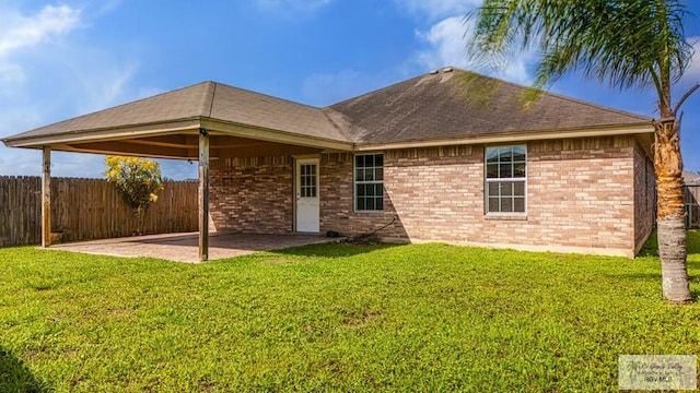 2400 Firenze St, Brownsville, TX 78520 - back of property featuring a patio, brick siding, and a shingled roof