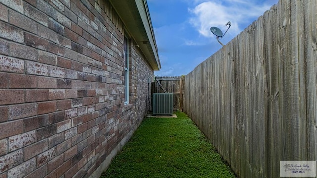 2400 Firenze St, Brownsville, TX 78520 - view of side of property with a central AC unit and brick siding