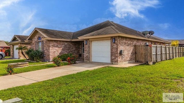 2400 Firenze St, Brownsville, TX 78520 - view of property exterior featuring an attached garage, brick siding, and driveway