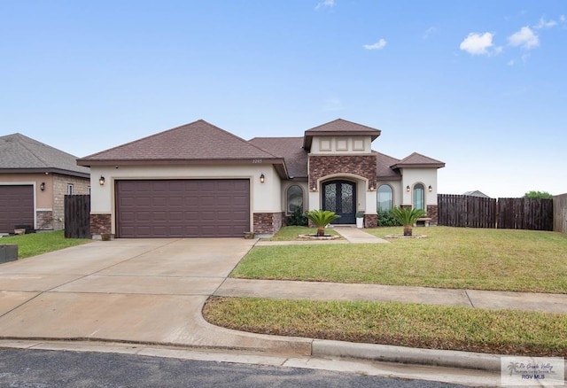 view of front of house featuring a front yard, a garage, and french doors