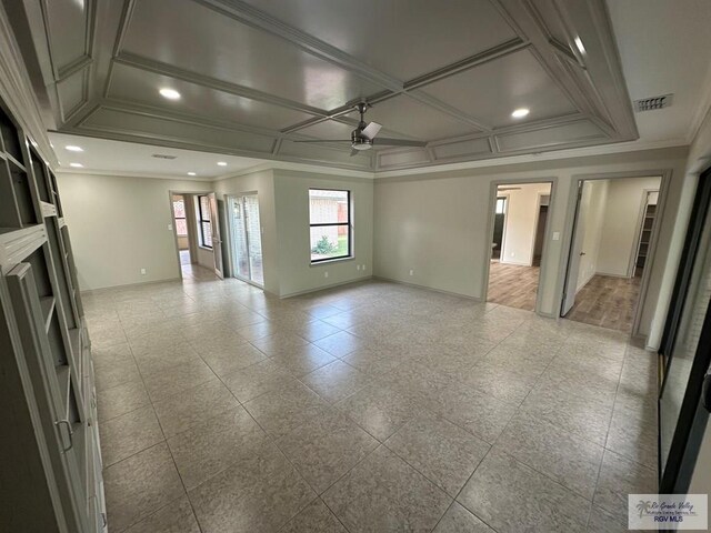 unfurnished living room with ceiling fan, ornamental molding, and coffered ceiling