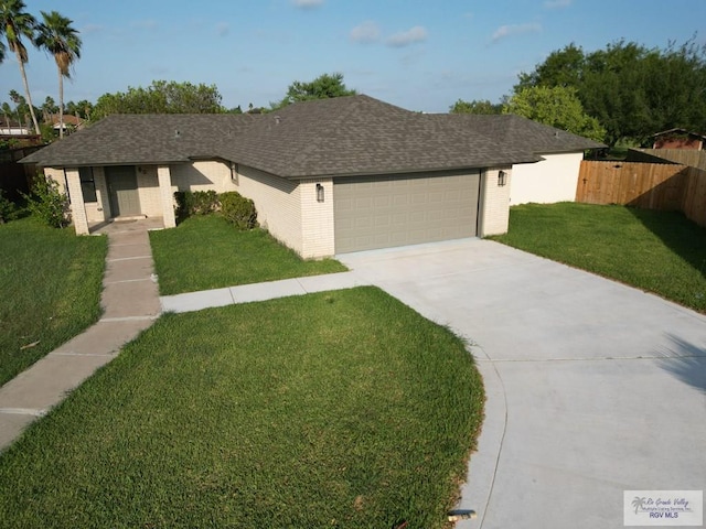 single story home with a front yard and a garage