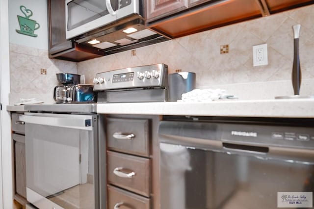 kitchen featuring backsplash, dark brown cabinetry, and stainless steel appliances