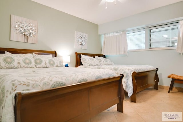 bedroom with ceiling fan and light tile patterned flooring