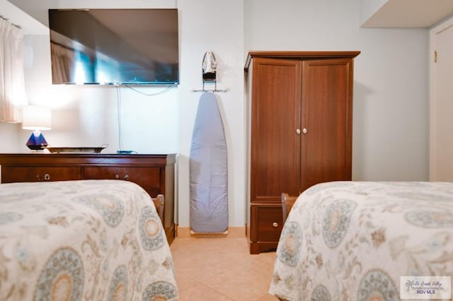 bedroom with light tile patterned floors