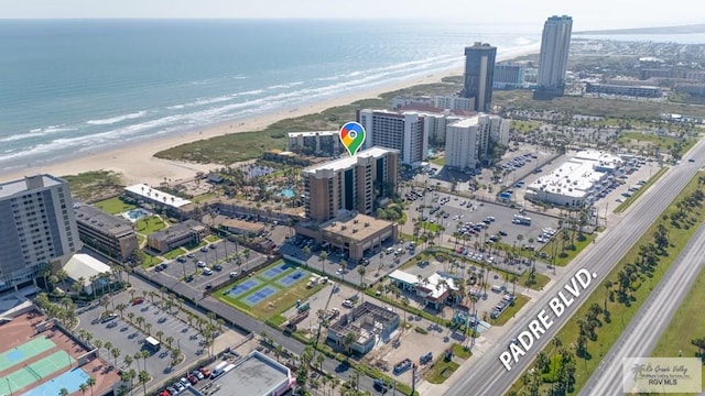 drone / aerial view featuring a water view and a view of the beach