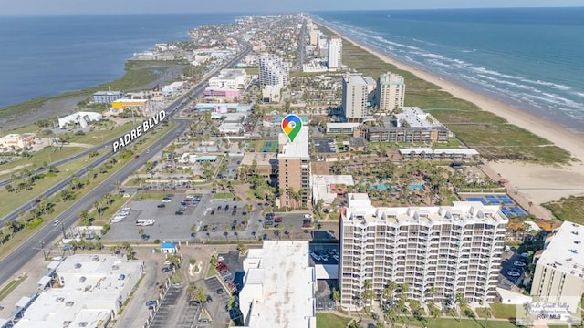 drone / aerial view featuring a water view and a beach view