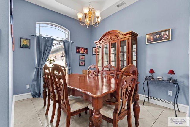 1730 Christian Cir, Harlingen, TX 78550 - dining room featuring a chandelier, light tile patterned flooring, a baseboard heating unit, and a tray ceiling
