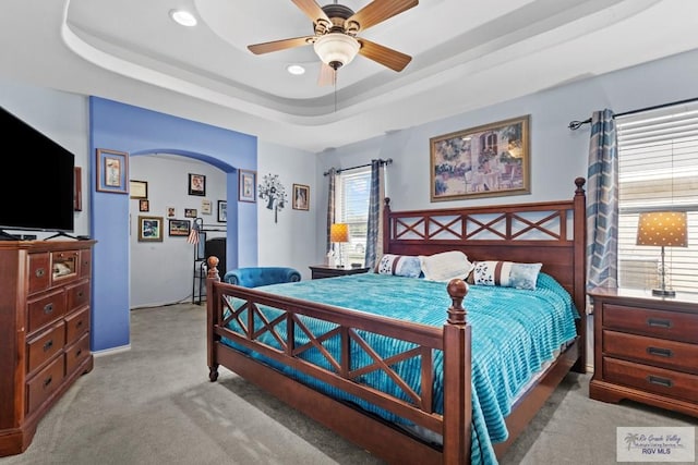 1730 Christian Cir, Harlingen, TX 78550 - bedroom featuring light carpet, a tray ceiling, arched walkways, and recessed lighting