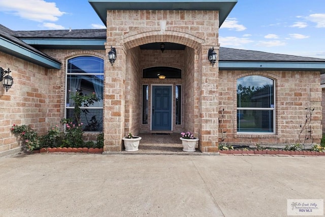 1730 Christian Cir, Harlingen, TX 78550 - view of exterior entry featuring a shingled roof and brick siding