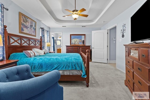 1730 Christian Cir, Harlingen, TX 78550 - bedroom featuring light carpet, a tray ceiling, ceiling fan, and ensuite bathroom