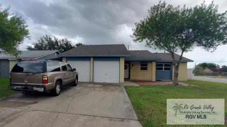 ranch-style house with a garage and a front lawn