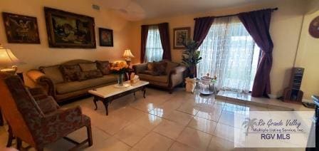 living room featuring tile patterned flooring and a healthy amount of sunlight