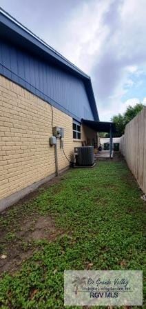 view of home's exterior featuring a lawn and cooling unit