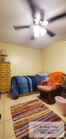 bedroom featuring ceiling fan and tile patterned flooring