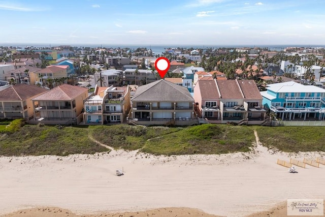 birds eye view of property featuring a view of the beach and a residential view