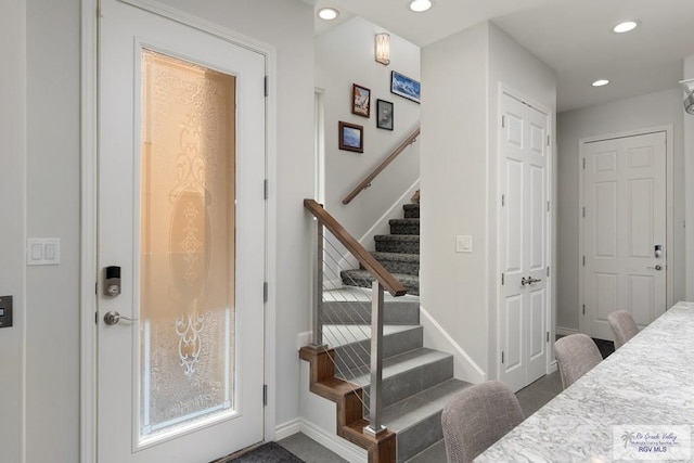 staircase with recessed lighting and baseboards