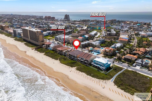 aerial view with a water view and a beach view