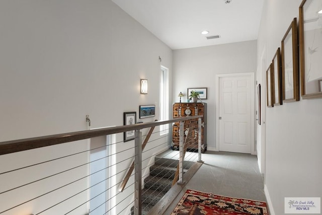 hallway featuring recessed lighting, an upstairs landing, visible vents, and baseboards