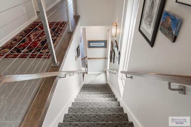 staircase with carpet flooring and baseboards