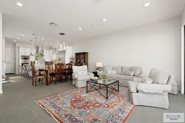 living room featuring visible vents and recessed lighting