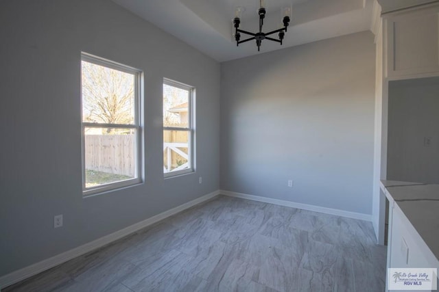 unfurnished dining area with baseboards